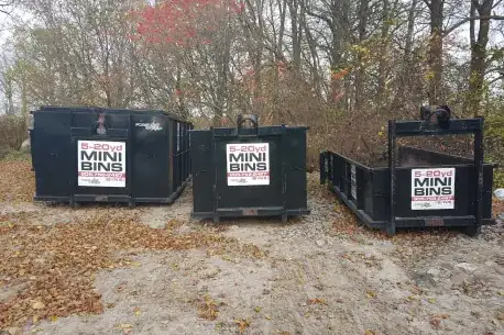 Forever Green dumpster bins placed on driveway with protective boards